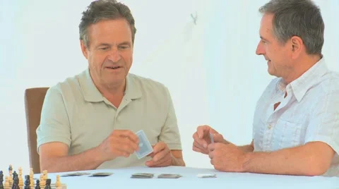 Friendly retired man playing cards Stock Footage