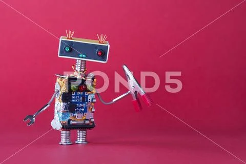 Friendly robotic handyman toy with red pliers. Pink background copy space Stock Photos