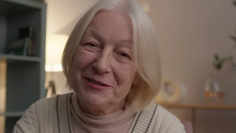 Friendly Senior Woman Talking To Camera During Online Conversation At Home 스톡 동영상 334736238