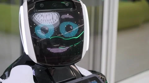 Friendly service robot with animated LED face interacting in modern tech Stock Footage 337775809