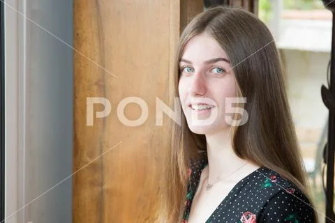 Friendly smiling young woman at home Stock Photos