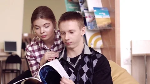 Friendly students meeting in a library Stock-Footage 73313851