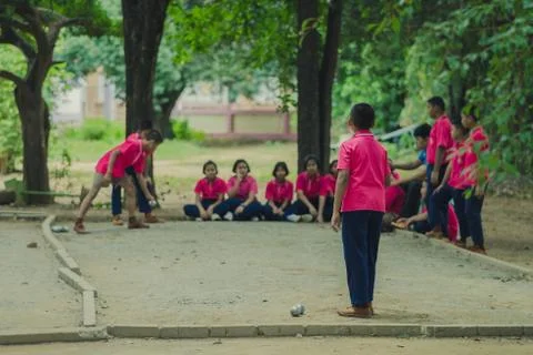Friendly Students playing petanque at school. Stock Photos
