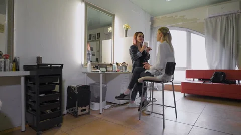 The friendly stylist working with his regular customer in a beauty salon Stock Footage 62313059