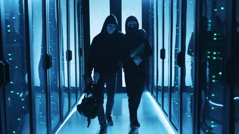 Friendly team of computer hackers sneaking into database, hugging and walking Stock Footage 120695285