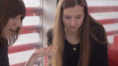 Friendly workers watching to a laptop screen and discussing Stock Footage 74308866