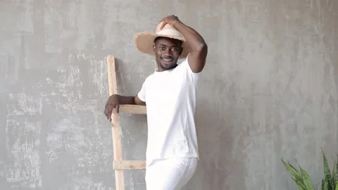 Friendly Young African-American Guy greets by taking off his hat. Video stock 203971456