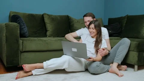 Friendly young couple having video call with relatives, waving to laptop screen. Stock Footage 149184732