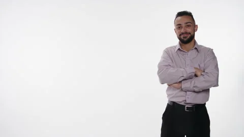 Friendly young man smiles and points towards graphic space Stock Footage 153476777