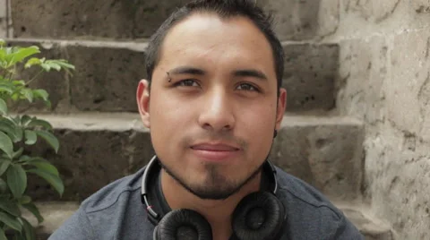 Friendly Young Man Smiling, Sitting in Urban Environment Stockbeeldmateriaal 52348780