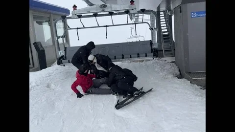 Friends All Fall Exiting The Ski Lift, Georgia, Bakuriani - 18 Feb 2026 Stock Footage 329691832