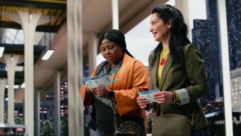 Friends analyzing bus ticket details and smartphone navigation app while walking Stock Footage 340203403