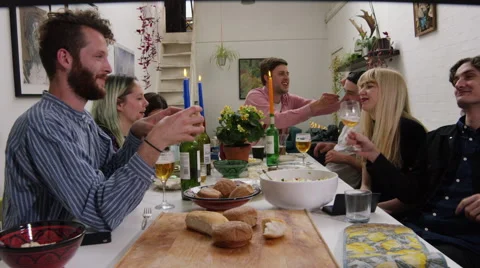 Friends and couples engaged in conversation at a dinner party Stock Footage 58582977