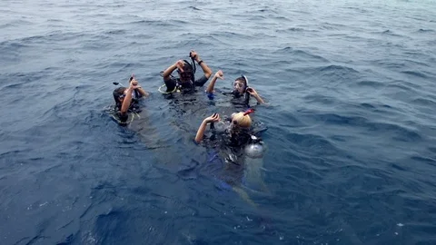 Friends And The Instructor Diving In The Ocean Stock Footage 125678634