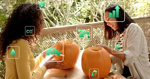 Friends approaching table and carving pumpkins while green overlay icons showing Stock Footage 316701916