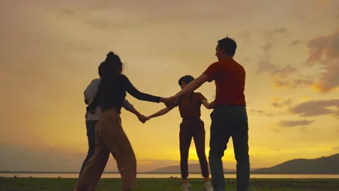 Friends are dancing and dancing on the fields, in the sunset atmosphere. Stock Footage 156208982