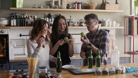 Friends are having a fun with cupkakes and laugh Stock Footage 73586632