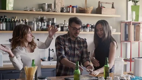 Friends are having fun in a home kitchen with flour Stock Footage 73576367