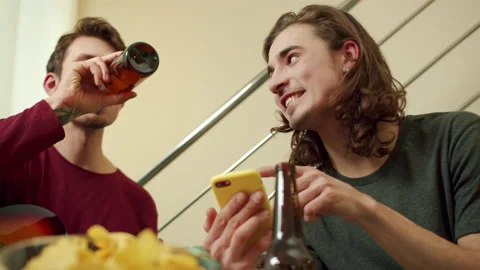 Friends are looking for something on the Internet and drinking beer Stock Footage 160628099