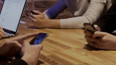 Friends are using modern gadgets at table in trendy place. Stock Footage 86495563