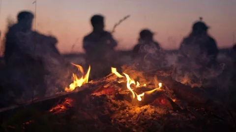 Friends Around Camp Fire At Sunset in Slow Motion Video stock 124096850