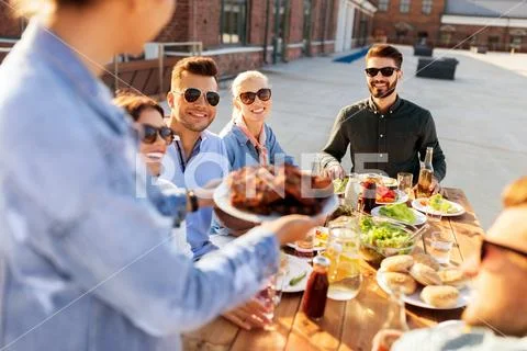 Friends at barbecue party on rooftop in summer Stock Photos