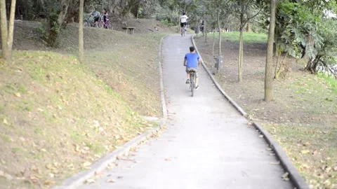 Friends bike riding down a path in a park bicentenario park El Salvador Stock-Footage 145863448