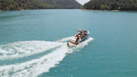 Friends on boat having fun, doing water extreme sport Stock Footage 111928160