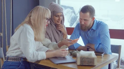 Friends browsing on smartphone and talking. Stock Footage 107740956