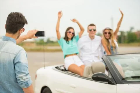 Friends in cabriolet Stock Photos