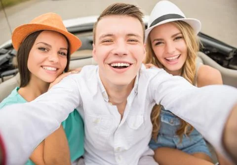 Friends in cabriolet Stock Photos