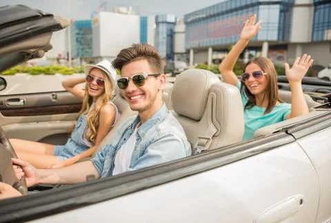 Friends in cabriolet Stock Photos