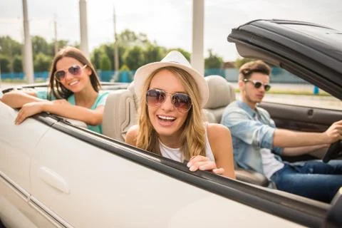 Friends in cabriolet Stock Photos