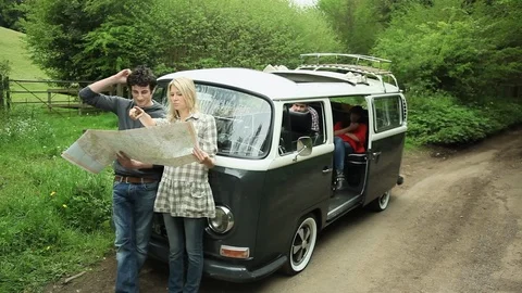 Friends with camper van looking at map Stock Footage 136553567
