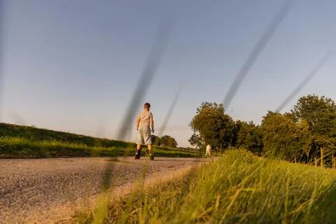 Friends can be seen inline skating along a peaceful path surrounded by gree.. Stock Photos