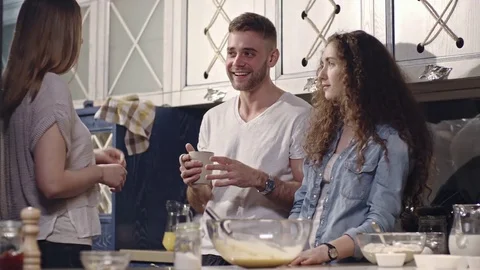 Friends Chatting and Drinking Tea while Baking in Kitchen Video stock 74816798