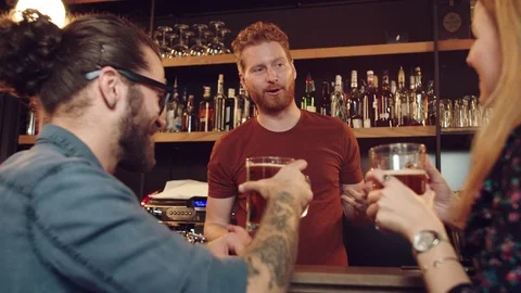 Friends chatting with batrender at pub. Stock Footage 125073509