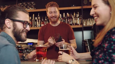 Friends chatting with batrender at pub. Stock Footage 125081776