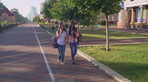 Friends chatting on smartphone and going shopping Stock Footage