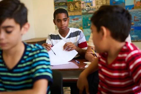 Friends Cheating During Test At School And Students Studying Stock Photos