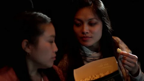 Friends in a cinema have fun while watching a movie Vídeo Stock 162430125