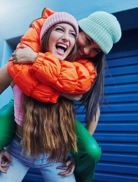 Friends, city fashion and piggyback girl with outdoor adventure, funny and comic Stock Photos