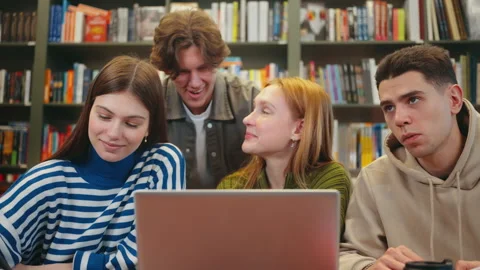 Friends Collaborating on Project in Library Stock Footage 265062633