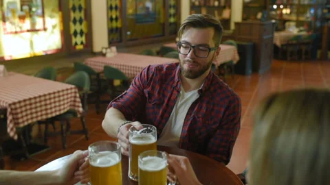 Friends communicate and drink beer in a cafe or a pub Stock-Footage 101428849