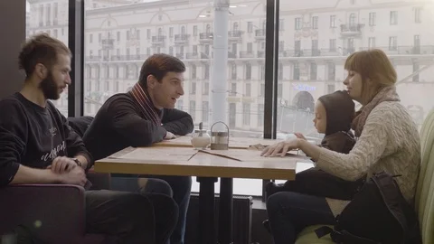 Friends communicate in a cafe. Group of Young Mixed Race People using phones in Stock Footage 87238720