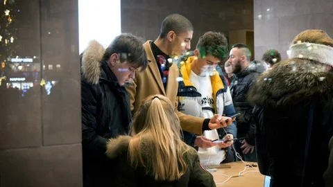 Friends comparing Android and iOS looking at latest iPhone 11 Pro Stock Footage 119965459