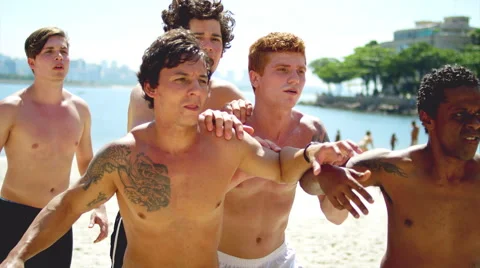 Friends compete to score a header on a beach. 스톡 동영상 47833597