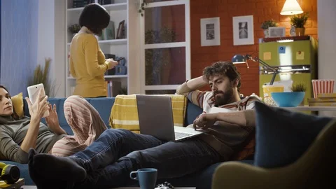 Friends connecting with their devices and ignoring each other 動画素材 128777541