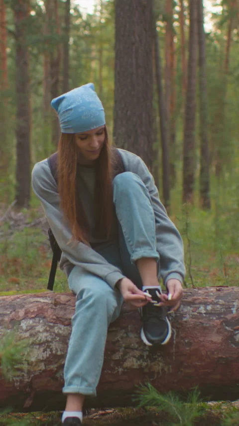 Friends Conversing on Fallen Tree During Forest Hike Stock Footage 316971875