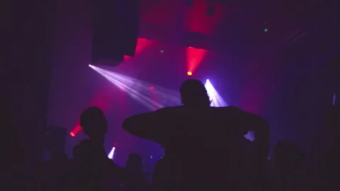 Friends dancing and sharing a good time in a nightclub with pink lights Stock Footage 237632820